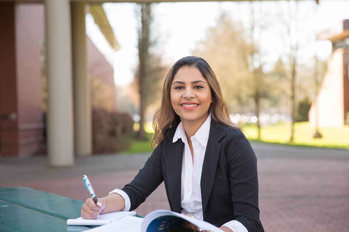 Student studying outside of library entrance